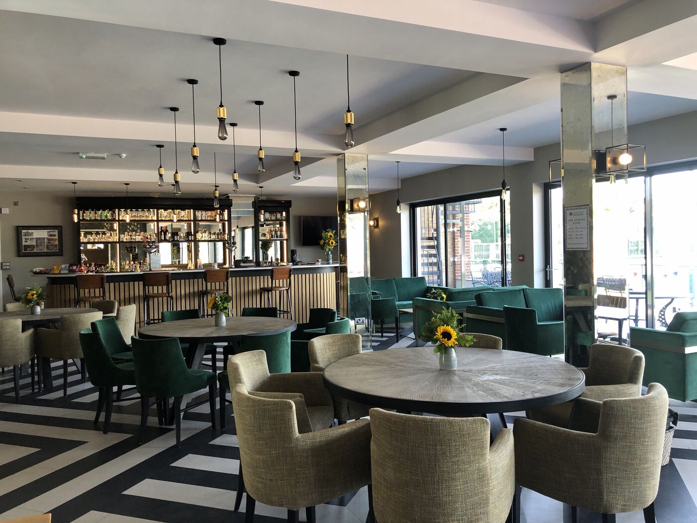 The Hidden Gem bar with velvet chairs and round tables