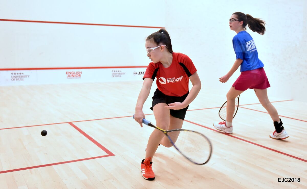 Two squash players mid-rally