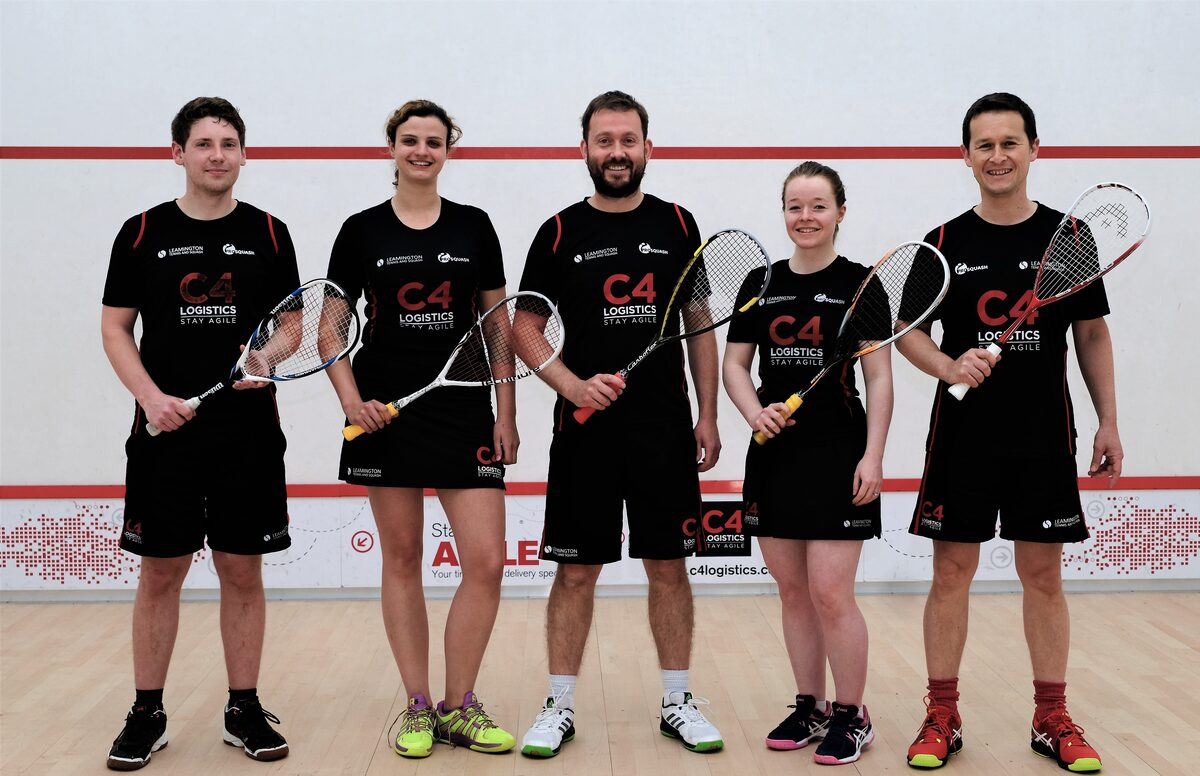 A squash team in club shirts on court